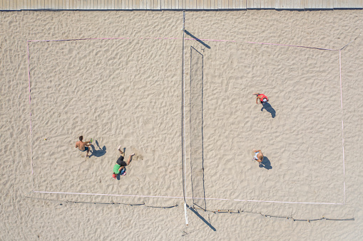 Group of people playing on the beach, from above