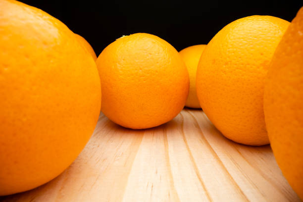 Macro view of oranges on wooden table, shot with macro probe lens