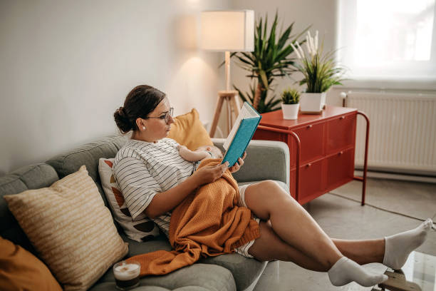 istock Women reading stories to her baby 1277046310