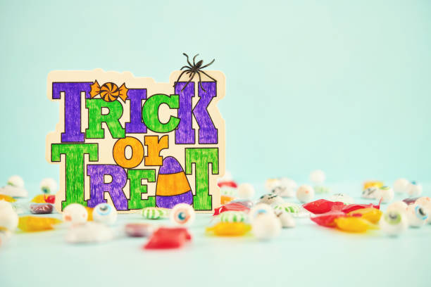 Trick or Treat Halloween background with candy and sign on blue background