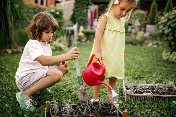 istock Kids playing with plants in back yard 1277047241