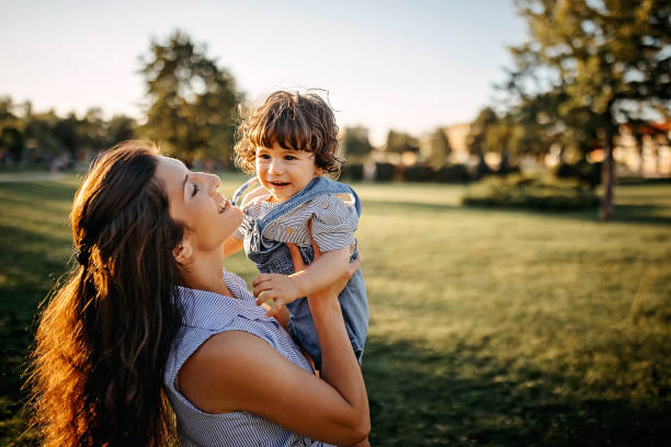 istock Mother playing with her baby in meadow 1277047375