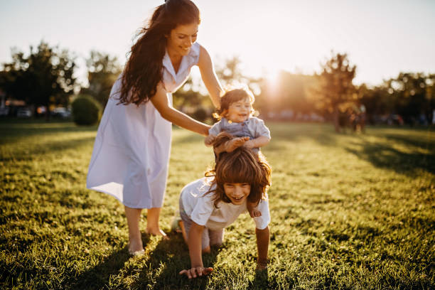 istock Mother playing with kids in meadow 1277047393