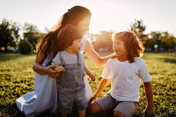 istock Mother playing with kids in meadow 1277047416