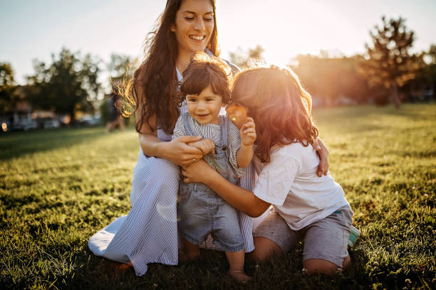 istock Mother playing with kids in meadow 1277047422