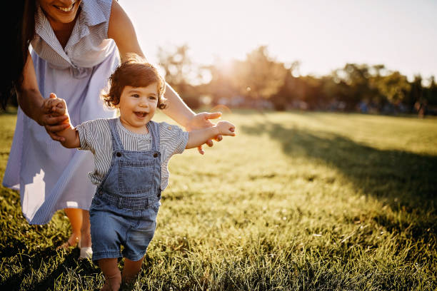 istock Mother teaching baby boy to walk 1277047432