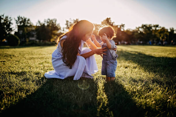 istock Mother teaching baby boy to walk 1277047437