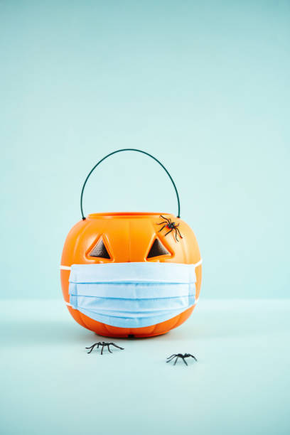 istock Empty Jack O'Lantern Trick or Treat Bucket with Face Mask Halloween Background 1277048732