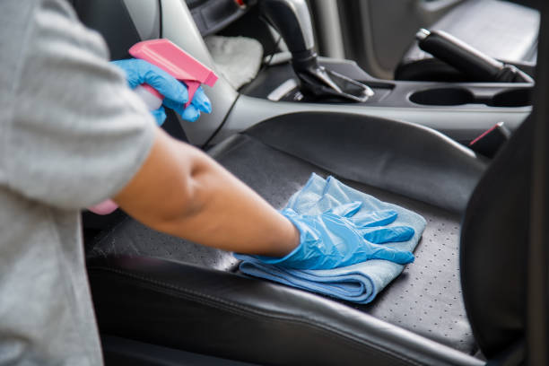 istock Hand wearing rubber gloves and using a blue microfiber cloth clean the car interior. Cleaning car  interior concept. 1277056773