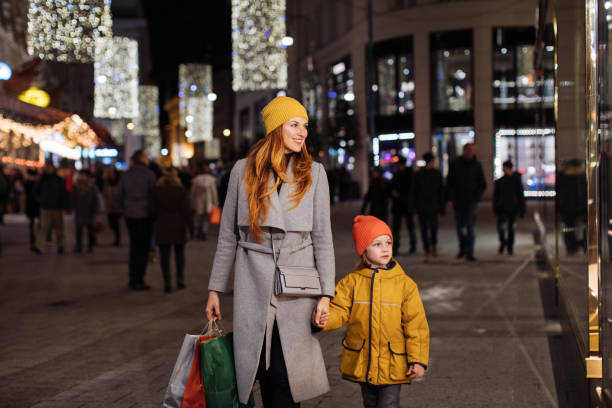 istock Boy looking at the store window with his mother 1277057038
