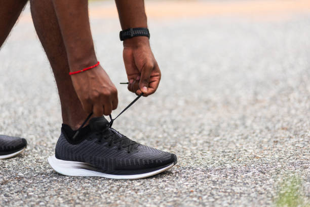 istock runner black man standing he trying shoelace running shoes 1277057986