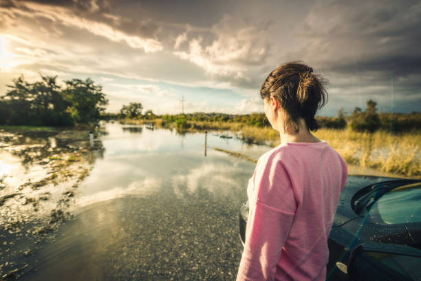 Woman walking on flooded road