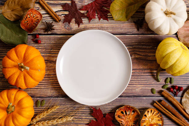 istock Autumn background with empty dish and dried leaves on dark wooden table 1277059459
