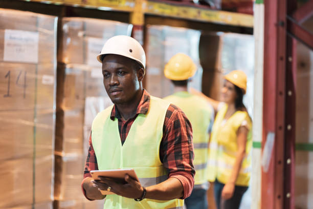 istock Multi ethnic warehouse worker in hardhat and vest work in cargo 1277063305