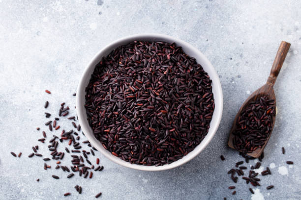 istock Black wild rice in a bowl. Grey stone background. Close up. Top view. 1277067367