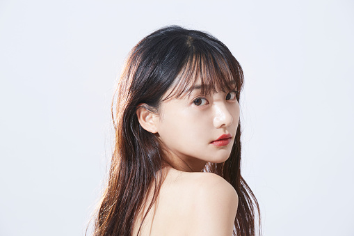 Beauty concept portrait of young Asian woman with soft highlights.