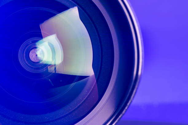 istock The camera lens with purple backlight. Optics. 1277070463