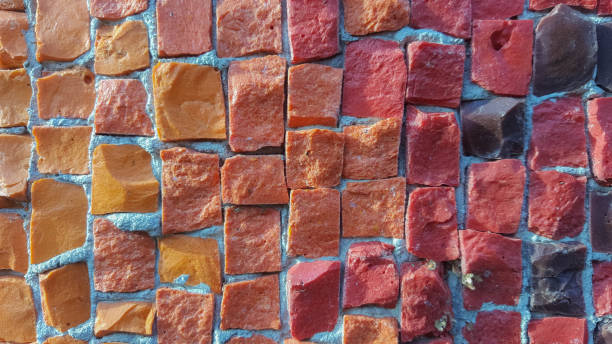 istock Beautiful old mosaic of small multi-colored square stones on an old wall 1277071721