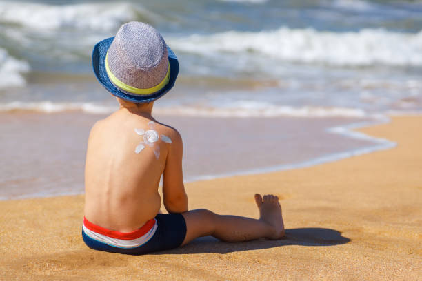 istock little boy with sunscreen cream on the shoulder 1277073989