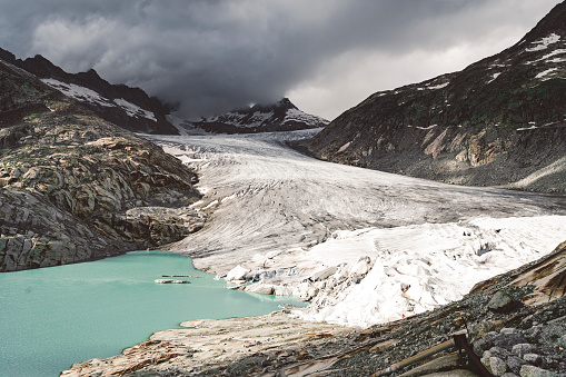 Melting Rhone glacier in Swiss Alps. End of the glacier melting into a lake.
