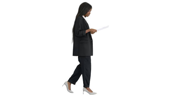 istock Serious african american woman reading documents while walking o 1277074188