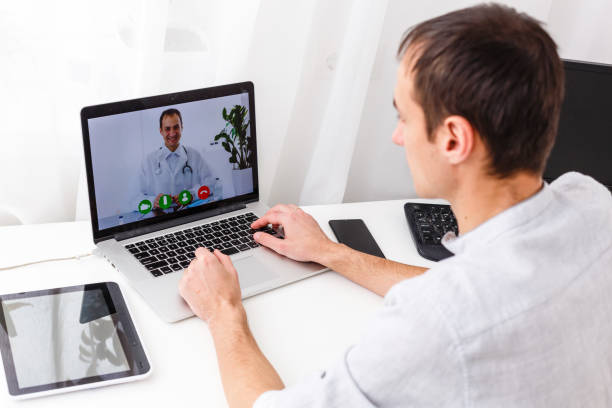 istock Man Having Video Chat With Doctor On Laptop At Home 1277076199