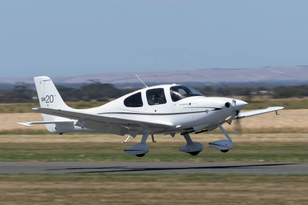 Cirrus SR20 private airplane departing Lethbridge airfield. Lethbridge, Australia - November 23, 2014: Cirrus SR20 single engine private airplane VH-NDI departing Lethbridge airfield. cirrus stock pictures, royalty-free photos & images