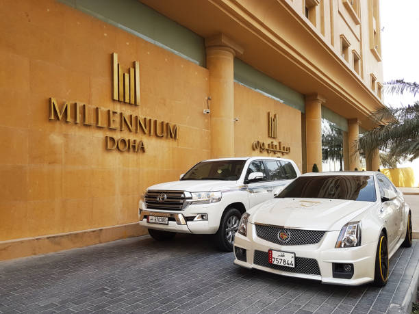 Doha Millennium Hotel Entrance Name along with Hotel Guest Pickup Car stock photo