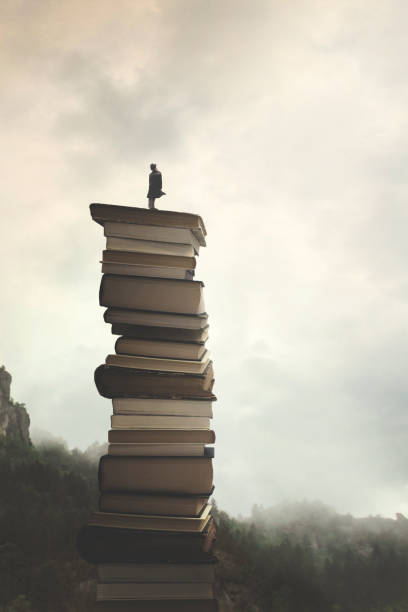 istock man successfully reaches the peak of knowledge by  climbing a stack of books 1277078832