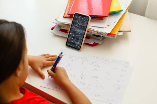 istock Distance learning online education, little girl writes formulas 1277078904