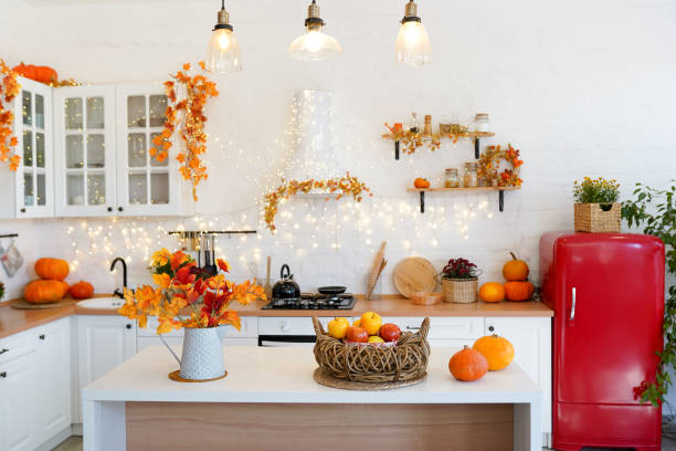 istock Autumn kitchen interior with pumpkins and falling leaves. Thanksgiving dinner and autumn decoration. 1277079799