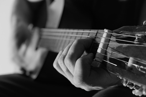 Guitar player with classic guitars. Chord, instrument.Musician with a guitar. Hands and guitar strings close-up.Hobby and music