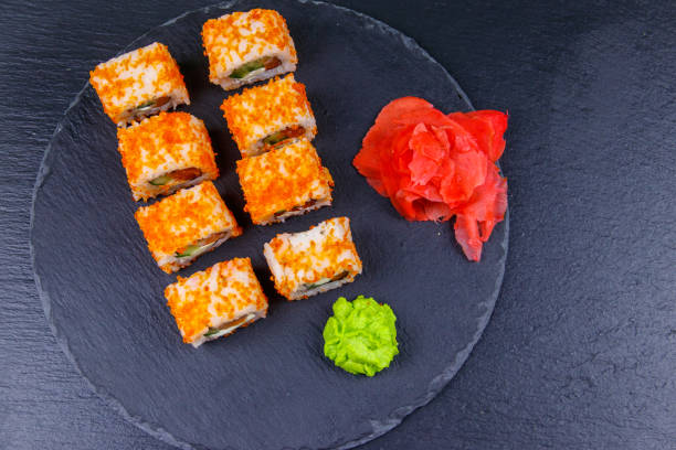 istock Sushi rolls Philadelphia on a black slate. Top view 1277081239