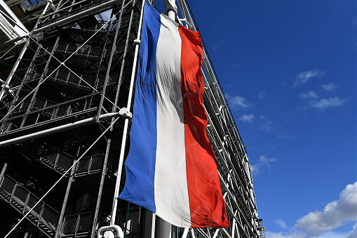 Paris, France-09 26 2020:A large French flag hanging from the structure of the Centre Pompidou, modern art museum in Paris, France.