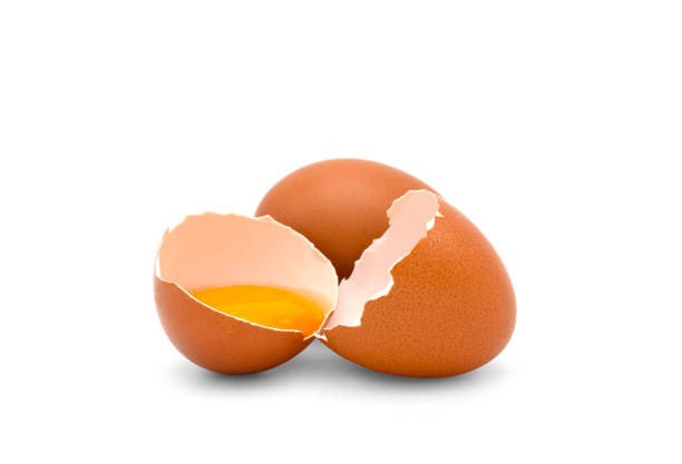 istock One egg and a half of chicken egg with yolk in egg shell isolated on white background. 1277083378