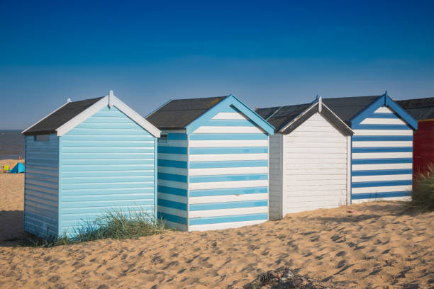 istock Colourful beach huts under a blue sky at Southwold beach in England 1277083714