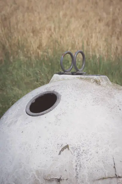 white glass container in front of a field in the autumn