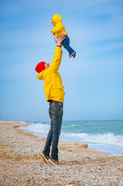 istock Dad with a baby on the seashore in colorful clothes. 1277085103