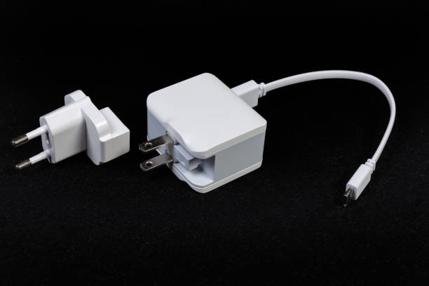 istock Mobile devices charger with combined AC plug and connected cable 1277085283