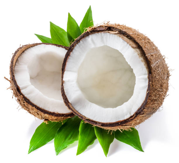 istock Split coconut fruit with white flesh over green leaves isolated on white background. 1277086357