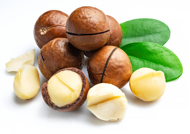 istock Macadamia nuts with peeled macadamia and leaves isolated on a white background. 1277086582