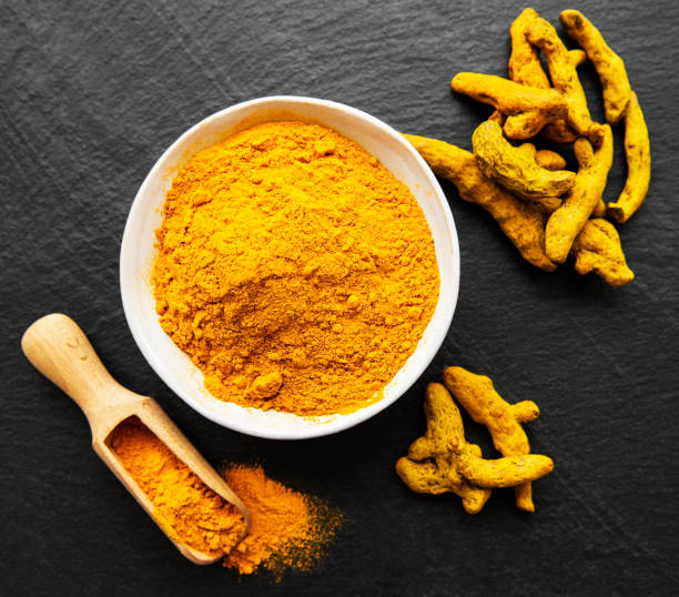 istock Turmeric powder and dry roots 1277086653
