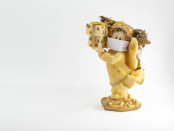 istock Angel figurine wearing paper mask 1277087990