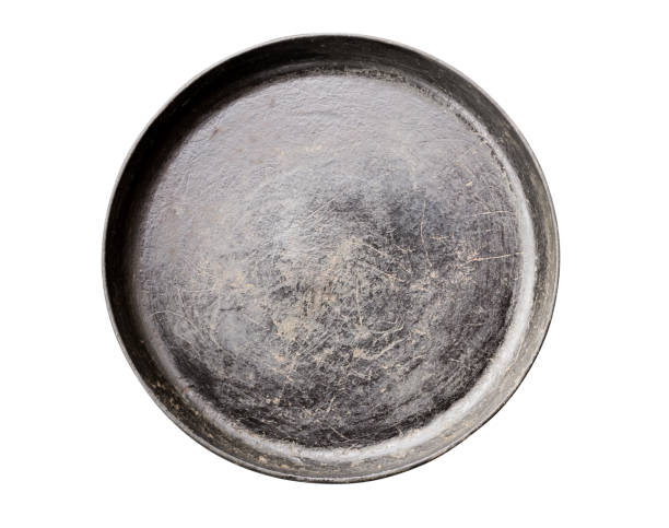 istock Old black cast iron Frying pan isolated on white background top view close-up 1277088616