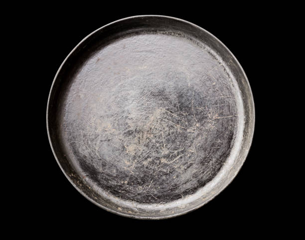 istock Old black cast iron Frying pan isolated on black background top view close-up 1277088652