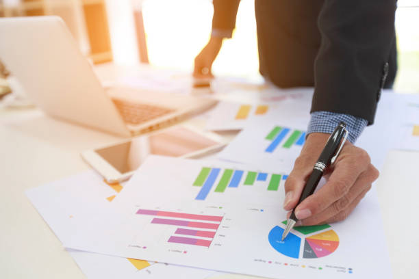istock Businessman analyzing investment charts with laptop computer on office desk table. 1277089175