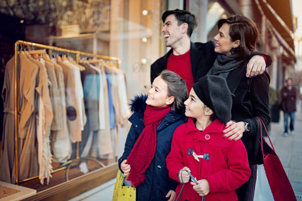 istock Happy family is looking store window at Christmas 1277089179