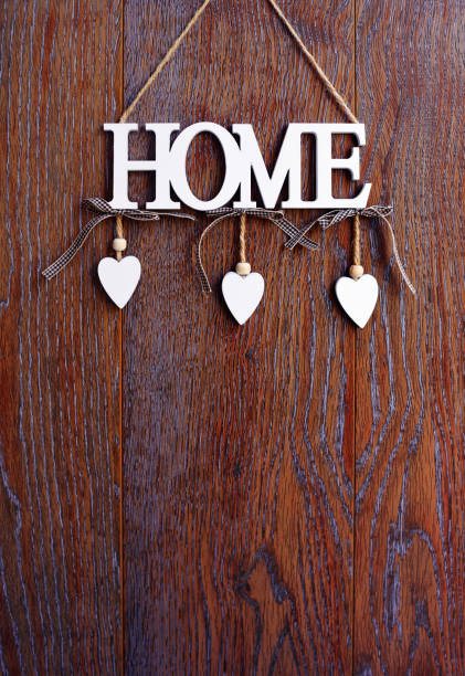 istock Word HOME, white letters with hearts on vintage board background with copy space 1277089404