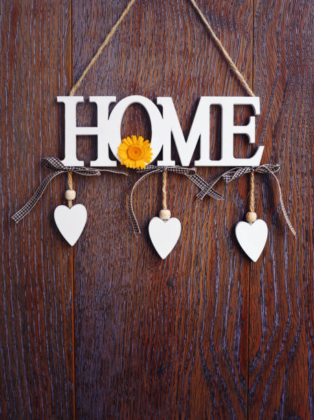 Word HOME, white letters with hearts on vintage board background with copy space