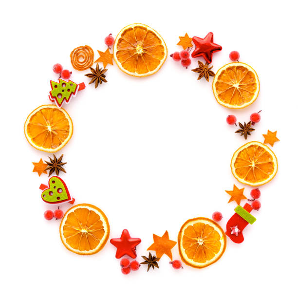 istock Round frame with dried orange, christmas decorations, anise stars on white background. Flat lay, top view 1277089502